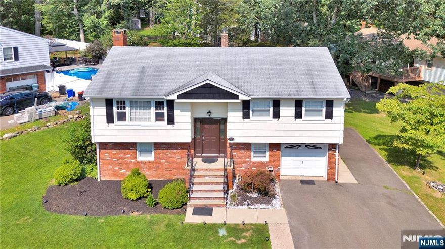 Discover the perfect blend of style, space, and location in this beautifully renovated home â€” a 4-bedroom, 1.5-bathroom bi-level gem nestled on one of North Haledonâ€™s most desirable streets. From the moment you step inside, youâ€™ll be captivated by the bright, open living spaces featuring a spacious living room, elegant dining area, and a sleek, modern kitchen, all designed for effortless entertaining. The main level boasts three generously sized bedrooms and a beautifully updated full bath. The ground level is an entertainerâ€™s dream, offering a fourth bedroom, a sprawling recreation room with a charming wood-burning fireplace, and sliding doors that open to a lush, expansive backyard â€” ideal for hosting or unwinding in serene privacy. This level also features a convenient laundry room, a half bath, and an attached two-car garage for added functionality. Enjoy proximity to local shopping, top-rated restaurants, and quick access to NYC via a nearby train station.