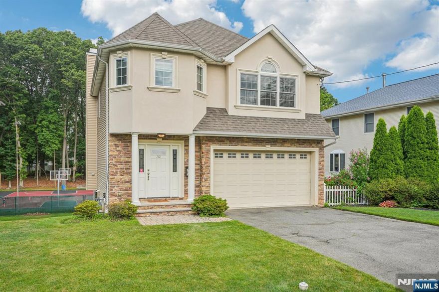 Discover comfort, space, and style in this beautifully maintained home, built in 2011 and tucked away on a quiet street in the heart of Emerson. Enjoy 9-foot ceilings throughout, starting with a welcoming entryway that leads into a bright and spacious living room featuring a wood-burning fireplace and sliding doors opening to a private deck. The formal dining room is finished with crown molding and chair rail, perfectly situated beside a spacious granite kitchen designed for both everyday living and entertaining. Upstairs, you will find a peaceful primary suite with a tray ceiling, walk-in and multiple closets, and a spa-inspired bath with whirlpool tub, shower, and double vanity. Three additional bedrooms offer generous closets and a tiled full bath with double sinks. The walk-out basement includes a full bath, kitchenette, and additional space for guests or recreation. Hardwood floors throughout, two-zone heating and air conditioning, and high-efficiency systems make this home the complete package. Don't miss it!