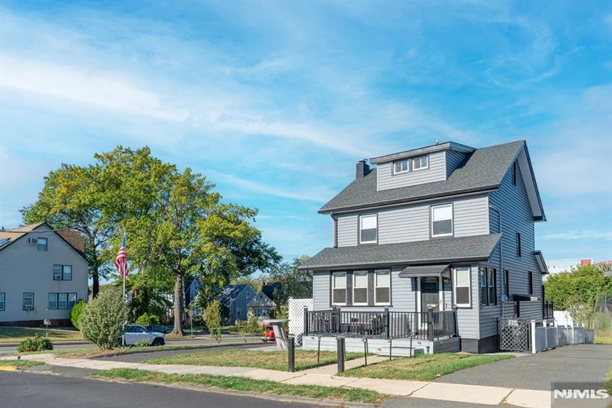 This beautifully renovated colonial sits on a LARGE CORNER LOT. With recent modern updates throughout including the kitchen, one and a half baths, fully finished attic, electric and recessed lighting along with three spacious bedrooms and lots of closets designed for both style and comfort. The inviting living room features a cozy wood-burning fireplace, creating the perfect setting for relaxing evenings or gatherings with friends. A brand-new Trex porch welcomes you at the front, while a new Trex deck in the back provides the ideal space for outdoor dining and entertaining. The full basement offers substantial storage. Every detail has been thoughtfully updated, blending classic design with contemporary finishes for a truly move-in ready experience. An oversized detached 2 car garage and a driveway allow for ample parking. Located in a walkable community known for its small-town feel and easy access to parks, local shops, and restaurants, the home also offers a convenient commute to New York City. Riverside County Park and the Passaic River are nearby, giving you plenty of opportunities for recreation and leisure. Don't miss the chance to make this stunning home your own.