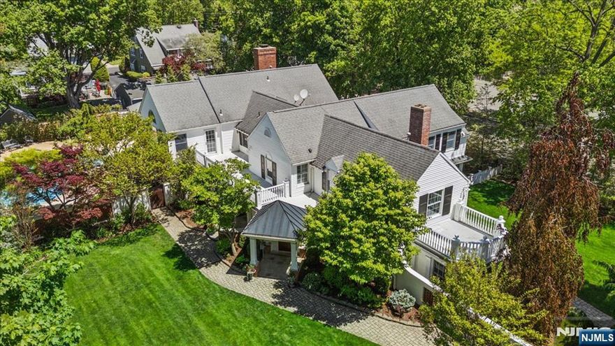 Elegant Custom Colonial in historic and thriving Morristown, offering exceptional privacy just blocks from acclaimed restaurants, shops, cultural venues, and direct train to NYC. Set on a beautifully landscaped lot, this 6-bedroom, 4.5-bath residence with 3-car garage blends timeless charm with a layout shaped by two thoughtful additions. The main level features hardwood floors, a great room with fireplace, formal dining room, and an indoor sunlit grill room with built-in grill. The gourmet kitchen includes rich wood cabinetry, center island, high-end appliances, and Wolf range with pot-filler. A coffered-ceiling family room opens to a sunroom, full bath, and screened-in porch. A private office with separate entry and powder room complete the level. The upper level offers a vaulted-ceiling primary suite with balcony and spa-like bath, junior suite with fireplace, 4 more bedrooms, and laundry.Step outside to a resort-like haven designed for both relaxation and unforgettable gatherings, featuring a paver patio, lush landscaping, in-ground Gunite pool with a jacuzzi and waterfall, and a charming cabana. A rare opportunity to own a spacious, character-filled home in one of Morristownâ€™s most coveted neighborhoods.