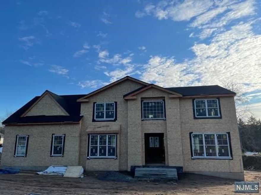 Custom 3082 SF Center Hall Colonial plus a 545 SF side entry garage on .41 acre. Custom builder w/over 40 yrs experience. 2 story entry foyer w/porcelain tile & L-shaped stairs. 1st Flr has 9ft ceilings and a 10ft family room w/coffered ceiling & gas fireplace. Kitchen w/shaker-style cabinets, stone counters, 5 burner stove w/chimney style hood. 2nd flr has large master suite w/tray ceiling, his/hers walk-in closets, free standing soaking tub, separate 2 sided glass shower, 3 more BRS, full bath & laundry room. Basement is 8 ft high w/sheetrocked ceiling for easy finishing. R-30-38 floor/ceiling & R-21 exterior wall insulation. Andersen 400/Pella windows, 3 1/4 stained oak hardwood floors, stone veneer/vinyl siding w/front elevation. Reinforced poured concrete foundation. Belgian block curbs, paver walkways & patio. Sprinklers front & rear. Close to schools/shopping/NYC transportation & steps to River Vale Country Club. Still time to call for selection of finishes.