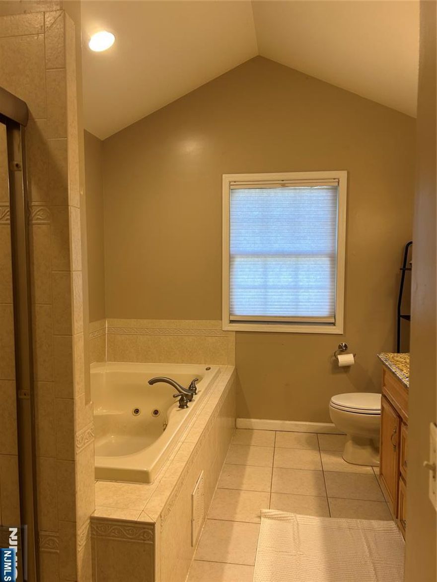 This is a 4-bedroom, 3 1/2 bath colonial home with full bathroom and 2 bonus rooms with large closets in the full-finished basement. The spacious master bedroom boasts a walk-in closet and ensuite with a deep-soaking jacuzzi. The elegant dining room with a tray ceiling is perfect for entertaining. The spacious eat-in kitchen boasts a center island, granite countertops, a tiled backsplash, and stainless steel appliances. French doors lead from the dining room to a bright and inviting sunroom with skylights. The open-concept family room, located just off the kitchen, is filled with natural light from its large windows, creating a warm and airy atmosphere.