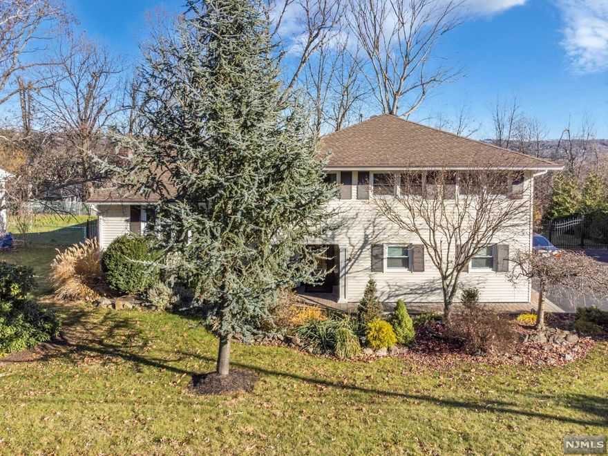 Well maintained and expanded split level home with a beautiful curb appeal nestled on 1/3 of an acre w/easy commute to highways offering 4 bedrooms and 3 bathrooms. Ground level foyer leads you to the family room or in-law suite w/full bathroom, laundry room and garage. Kitchen w/sep dining area, formal living room, grand dining room/great room that leads to the deck completes the first level. Second floor offers a Master bedroom w/en-suite bath, plenty of closets, 3 add'l bedrooms, full bath. Basement is partially finished offering two spacious rooms, can be used for a den and office, storage/utility room. Bonus features: cathedral ceiling in the addition, in-law suite capabilities w/ground level entry, hardwood floors, sump pump, in-ground sprinkler system, newer: roof, central air, windows and garage doors, patio w/fire pit, spacious deck, paver walkway, fenced in two-tier yard, large driveway w/two car built-in garage, very desirable location, blue ribbon elementary school!