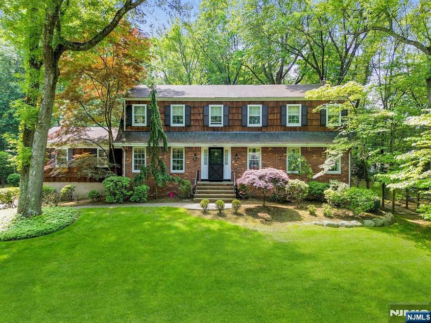 Welcome to the East Hill of Norwood! Exquisite Center Hall Colonial on Nearly an Acre of Lush Property in Norwood on Cul-de-Sac! Welcoming foyer that opens to a spacious formal living room and a banquet-sized dining room, with gleaming hardwood floors. The inviting family room features a charming brick fireplace and sliding doors that lead to a delightful screened-in porch, ideal for relaxing or hosting guests. The timeless eat-in kitchen showcases rich wood cabinetry, crisp white countertops, stainless appliances, and a lovely bay window that fills the space with natural light. Just off the kitchen, youâ€™ll find an expansive den complete with a custom barâ€”an exceptional space for entertaining. A convenient laundry room and half bath completes the first level. Second level, you will find the luxurious primary suite including a custom walk-in closet, vanity area, and an updated full bath. Three additional generously-sized bedrooms and another full bath complete this level. The professionally landscaped property offers a serene and private backyard oasis, featuring a beautiful paver patioâ€”Totally pavered driveway leading to the 2-car garage. This exceptional home offers the perfect blend of classic charm, modern comfort, and unbeatable location. You will absolutely love living here!