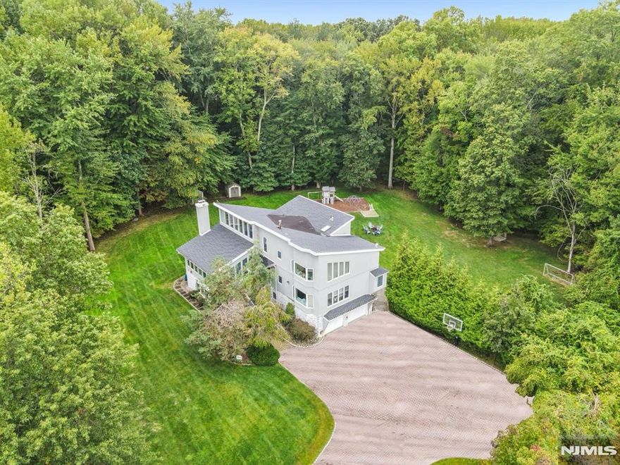 Your Private Oasis Awaits: 0.87 Acres of Contemporary Serenity! Rarely does a home of this caliber become available in such a premier location. Nestled on a sprawling 0.87-acre lot that feels more like a private park than a backyard, this 5-bedroom contemporary home is the ultimate escape. Located on a quiet, prestigious cul-de-sac, the property offers a peaceful retreat while maintaining a bold, modern aesthetic. The floor plan is designed for both grand-scale entertaining and intimate daily life, featuring sun-drenched rooms and an organic connection to the outdoors. Whether youâ€™re enjoying a quiet morning on the patio or hosting a summer soire on the massive lawn, this home offers a lifestyle of quiet luxury that is simply unmatched in Norwood. House is not in a flood zone. The sellers have never had any water issues and no claims during ownership. Sold as-is with no known issues. Call Listing agent Maria Hiletzaris with any questions and showing requests.