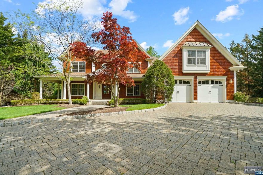 Welcome to this breathtaking farmhouse colonial built by a renowned builder with unparalleled attention to detail. This stunning 5,700 sq ft home (not including basement & garage) is a masterpiece of architectural trim, custom moldings, raised panels, coffered ceilings & baseboards throughout. The cherry library w/ inlaid wood & custom-built-ins is the perfect place to curl up w/ a book or work from home. The oversized kitchen features a Wolf dual fuel stove & large eating area overlooking the Gunite heated pool w/ cascading stone waterfall. The adjacent custom cabana boasts an outdoor bar, TV, & half bath. Lower level is the star of the show, offering an additional 3,000 sq ft of living space with 9" ceilings. This level features a gym, home theater, home office, full bth, full bar, AND it's own basketball court one level down. 4 car garage- 3 attached, 1 detached from home w/ loft space. Radiant heat & hardwood throughout. Close to schools, parks, shops, and restaurants