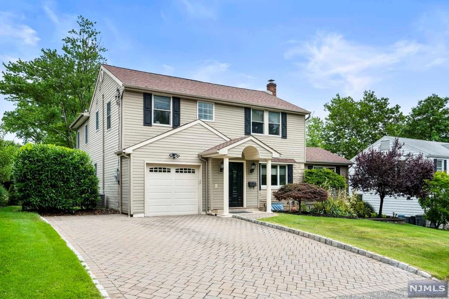 Find your ideal home in this professionally renovated property. This colonial-style property features impeccable finishes from beautiful hardwood floors, gourmet designer kitchen with stainless steel appliances and soapstone countertop, to custom closet systems on all closets. Outside is a spacious lawn and an area set aside for gardening. Single garage with driveway wide enough to fit four vehicles. The 1st floor offers a huge family/living room, light-filled office, and an updated chef's kitchen opening to the dining room. The eat-in kitchen/family room also leads to a large deck overlooking the backyard and stone patio. 2nd floor offers a Master suite & master bathroom and updated closet. 3 bedrooms with a full bathroom and laundry room. This home feature 4-zone heating system,tankless water heater,and in-ground sprinkler system. The property is located on a beautiful tree-lined residential street close to parks, NYC transportation, Blue-ribbon schools. You must see!!