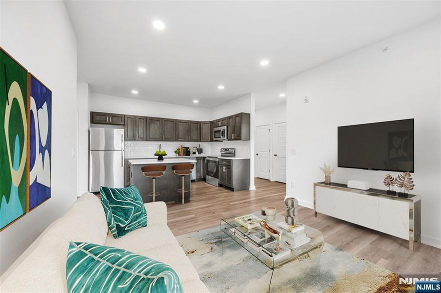 Discover pure luxury in this stunning, new construction 2 Bedroom / 2 Bathroom apartment conveniently located in highly sought after East Rutherford. Stretching across 945 SqFt, this brand new unit features gleaming wood floors, in unit washer/dryer, multi-zone heating and cooling, two balconies and plenty of sunlight throughout the day. This beautifully designed home includes entry foyer, kitchen, living room / dining room combo w/ balcony, Master Bed w/ ensuite bathroom and balcony, guest bedroom, full bathroom, and laundry. Chef's kitchen features SS appliances, custom cabinets, quartz countertops, and breakfast bar. 315 Railroad is a one-of-a-kind building featuring virtual doorman, resident patio, dog run, and ample parking. Conveniently located just steps from downtown East Rutherford & Rutherford, NJ Transit train station and bus stop, restaurants, shopping, parks, and schools. This rare opportunity is one you don't want to miss!