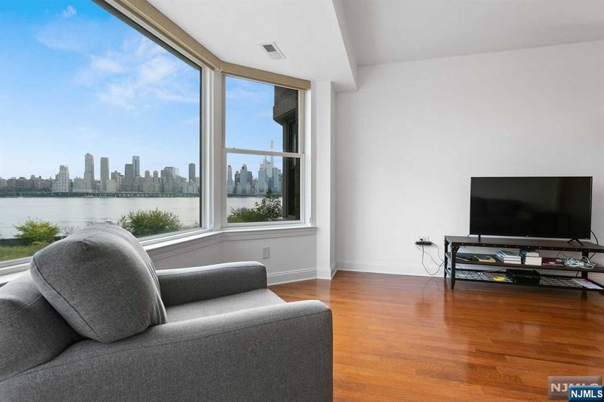 This stunning one-bedroom rental offers everything you need for luxurious living. Enjoy breathtaking views of New York City from your spacious condo. The gourmet kitchen features stainless steel appliances, in-unit washer/dryer for your convenience and elegant two-toned hardwood floors. Located on the second floor, this unit offers easy access to both the stairs and elevator, leading directly to an entrance/exit and your dedicated parking spot just steps away. The building offers 24-hour concierge service, a pool, fitness center, and a children's play area. Commuters will appreciate the free shuttle service at your doorstep, or you can walk to the nearby ferry and light rail stations. The 158 bus to NYC is just steps away, and the building is conveniently close to the Lincoln Tunnel and major highways. Everything you need is within walking distance, including a grocery store, pharmacy, dry cleaner and coffee shops/restaurants. Whole Foods/Trader Joe's are just a short drive away.