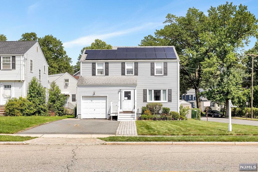 This 3 bedroom Oak View colonial is just waiting for you! A front entryway with closet leads you into the spacious living room, where you'll see beautiful hardwood floors running throughout the home. The formal dining room is cozy & ready to entertain. A heated room off the dining room is perfect for that home office or just to sit and enjoy the day. An updated kitchen with granite countertops & half bath complete the first floor. The second floor boasts a full bath, a large master bedroom & 2 more ample sized bedrooms, all with plenty of closet space, and each with ceiling fans. There is an insulated pop-up attic perfect for storage. The basement is full with french drains and great ceiling height. The transferable solar panels on the roof can save you money! Just seconds away from NYC transportation!