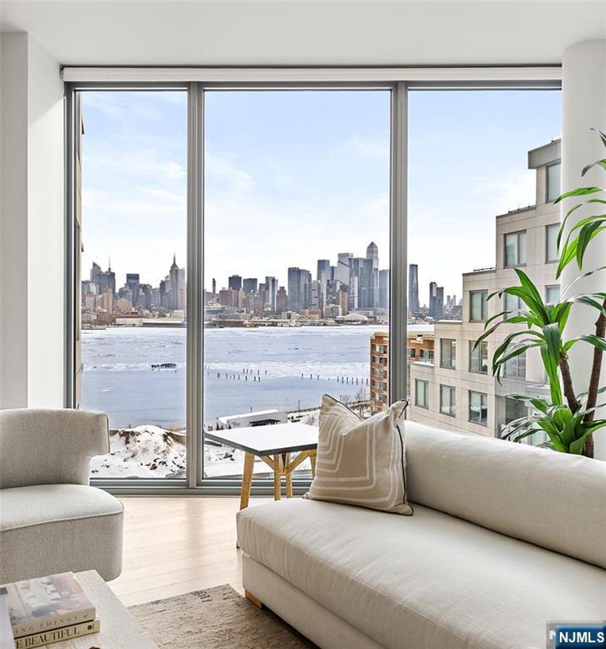 Introducing an exquisite home featuring unique full-panel glass floor-to-ceiling windows, offering stunning protected panoramic views of Midtown and Downtown Manhattan to the southeast! This stunning residence boasts a high-end kitchen equipped with custom Italian Pedini cabinetry, generous Aspen quartz stone countertops with a waterfall edge, and a Bosch appliance package, including a Thermador built-in refrigerator, ideal for cooking enthusiasts. Pamper yourself in two luxurious en-suite bathrooms with Carrara marble floors and walls, custom Italian Pedini vanities topped with quartz countertops, and Moen faucets complemented by luxurious rain shower heads. The spacious bedrooms offer ample closet space, and the entire home is adorned with beautiful oak flooring throughout. Modern Restoration Hardware lighting fixtures and the convenience of in-unit laundry complete the package. Residents enjoy exceptional 40,000 SF of resort-style amenities, including a 24/7 concierge, multiple resident lounges, an infinity pool, a 6,000 sq. ft. fitness center with a yoga studio, aerobic studio, and weight room, two saunas, a thoughtfully designed play area for children, two landscaped community decks with fire pits and BBQs, all overlooking The Greatest City in The World. Benefit from an estimated 1% tax abatement through 2038