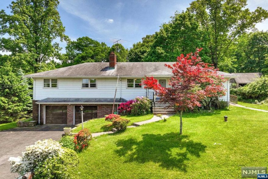 Don't miss this incredible opportunity! The first floor boasts four spacious bedrooms, two bathrooms, a living room, a dining room, a kitchen, and a family room with a wood-burning fireplace and a slider leading to a large deck. The finished basement offers an expansive living area with another wood-burning fireplace, an eat-in kitchen, a bathroom, and a flex room/office, making it an ideal setup for an in-law suite. Conveniently located near Rt 208, public transportation, parks, and schools, this home also features a well water system with plumbing ready for a seamless connection to public water. This home is a must-see in a great location!