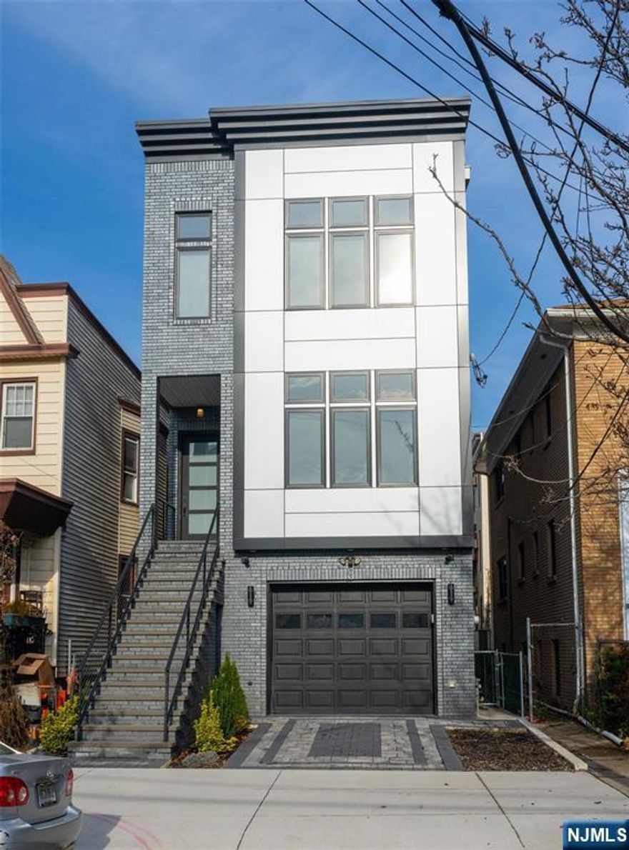 Young, exquisitely maintained and with a top notch JC heights location, do not miss your chance! This fully hardwood floor, 3 bedroom 2.5 bathroom duplex is as spacious as it is luxurious! Live in style in this open layout unit that includes a modern kitchen w/ custom cabinets, stainless steel appliances and waterfall island with quartz countertops. A spacious living and dining area welcomes you in and makes way for the high end, comfortable living spaces. A huge tandem shared garage spot is included. Easy travels to all major public transportations, Journal Square, PATH, and bus. Don't miss out on easy access to what Jersey City has to offer!