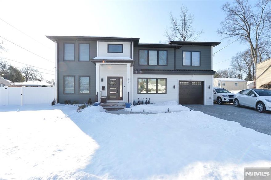 A stunning showcase of modern craftsmanship, this exceptional residence offers approximately 3,000 square feet of refined living space, plus a fully finished basement. From the paverstone driveway with ample parking, built-in garage, extended fencing, and private fenced yard, every detail speaks to elevated living. Inside, a sun-filled first floor unfolds with rich hardwood floors and seamless flow from the inviting living room to the elegant dining area and into the modern eat-in kitchen. Anchored by a striking center island, the kitchen features premium appliances including a built-in microwave and range, countertop cooktop, dishwasher, refrigerator with ice maker, garbage disposal, and water softener system. A private first-floor bedroom, full bath, and stylish powder room complete the level. The second floor offers a junior suite with a private bath, two additional generously sized bedrooms, a hallway bath, and a luxurious primary suite. The primary retreat boasts a tray ceiling, dual walk-in closets, and a spa-inspired ensuite with heated floors, bidet, double vanity, double-head shower, and an indulgent dry sauna. The fully finished basement provides expansive additional living space with a recreation room, private office, large laundry room, and abundant storage. Notable upgrades include dual gas HVAC systems, 200-amp electric, gas backup generator, Tesla charger, and a 360-degree security camera system.