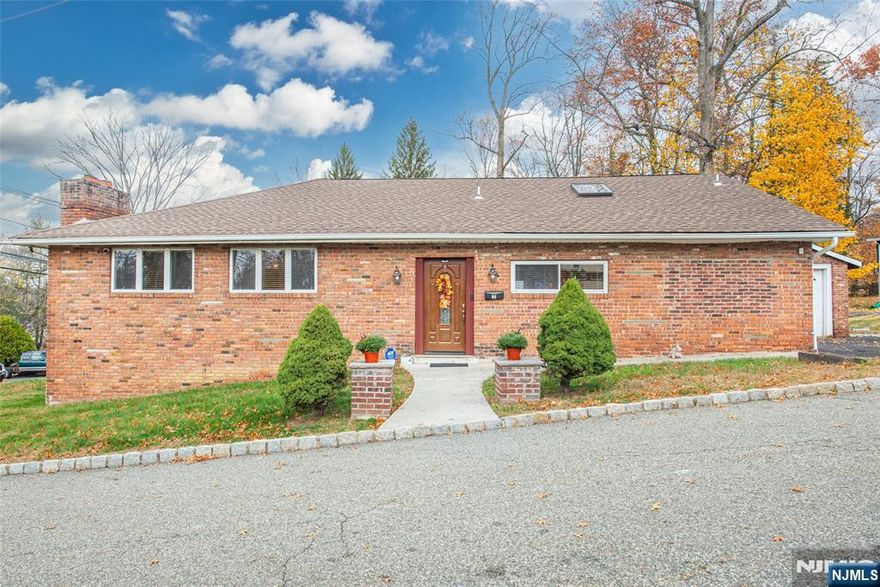 Call Reiley Phelan for all showings and info 201-951-4877. Welcome home to this beautifully maintained all-brick 3-bedroom, 2 full bath, ranch ideally located in the desirable Packanack Lake community. Step inside the tiled entry foyer featuring a roomy coat closet that opens to a spacious living room with gleaming hardwood floors, recessed lighting, and a cozy wood-burning fireplace, ideal for relaxing evenings. The vaulted eat-in kitchen is a true showstopper, boasting a skylight, granite countertops, stainless steel appliances, soft-close cabinetry, a large island with breakfast bar, and tiled floors. Sliders lead from the kitchen to a lovely patio overlooking the backyard, perfect for entertaining or simply enjoying your morning coffee. The partially finished walk-out basement, complete with heat and a second wood-burning fireplace, offers fantastic bonus space for a rec room, home office, or gym. Additional storage is easily accessible with a convenient walk-up attic. A detached 1-car garage adds extra functionality to this already impressive home. With thoughtful upgrades throughout and a layout designed for both comfort and convenience, this home is ready to welcome its next owners! Enjoy all the benefits of Packanack Lake living: highly walkable 2.5 miles around, 2 beaches, ball fields, tennis, pickleball, 9-hole golf course, 2 clubhouses (year-round events and rentable), sports&clubs! PLUS "Lake Drive Tavern" with an upscale comfort food menu coming Spring 2026!