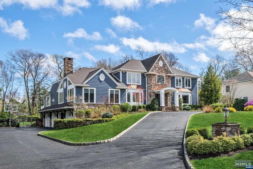 Welcome to comfortable living on a grand scale! This handsome center hall colonial in the Sicomac district welcomes you with striking HardiPlank siding with stone and copper accents, circular driveway, and 4-car garage. Inside lies numerous cathedral ceilings, quality trim work including multiple built-ins, spacious family and great rooms for versatile living and entertaining, oversize windows throughout for beautiful sun-filled rooms, 3 fireplaces, and a custom kitchen with grand island with seating for six. A gorgeous first floor primary suite features a fireplace, large bath, two walk-in closets, and private office. A stunning open staircase leads to 4 large second floor bedrooms, as well as a lower-level recreation room with full bath, mudroom, and gym. The backyard oasis includes a tiered deck and paver patio; free form pool with whirlpool spa and rock waterfall; cabana with changing area and bathroom; and gorgeous outdoor kitchen with high end appliances. A must see!