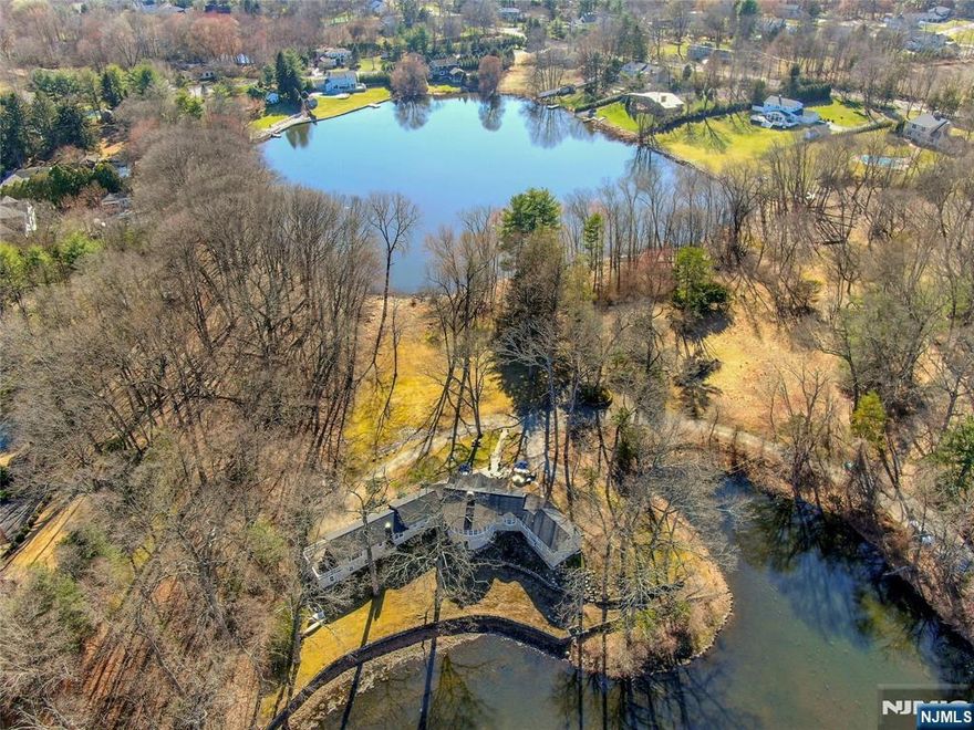 Tucked between 2 picturesque lakes, wrapped in 4.5 acres of tranquility, this home feels like your own private retreat. Large 2 bedroom ranch with separate 1 bedroom apartment located on the borders of Franklin Lakes, Wyckoff, and Ramsey, surrounded by nature, just a short ride to Boulder Run, restaurants and trains to NYC. Inside enjoy bright vaulted rooms and cosy spaces, whether you are in the updated kitchen with designer lights and huge island, or curled up in the vaulted living room with oversized fireplace and dormered roof, you're never more than a glance away from a peaceful water view. The dining room curves gracefully toward Turnerâ€™s Lake with 15 windows capturing every shift of light. Sunsets from the lemonade porch are magical. The two large, private primary suites, each feature brand new bathrooms and walk-in closets, and anchor opposite ends of the home, with perfect for privacy for guests, or family alike. The separate apartment includes its own kitchen, 1 bedroom, bathroom, laundry and private deck offering endless possibilities for guests, caregiver, office sanctuary, or income opportunity. 3 car attached garage and walk out basement with bar, includes potential for more living space or add another level up. Here life feels slower, more meaningful. Ice skating, kayaking, fishing, quiet mornings with coffee on the porch. This home restores you, and NYC is only 30 miles away. A peaceful haven waiting for it's next chapter and your story. Owner holds NJ RE Li