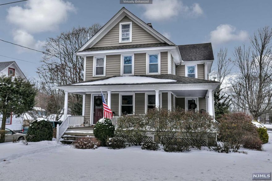 This lovely Colonial style home was build in 1928 and has been well loved and maintained. The welcoming Lemonade Porch reminds us of days gone by, when neighbors would "sit for a spell" while they enjoyed Sweet Tea and Lemonade. Pride of ownership is evidenced throughout by custom woodwork, hard wood & new LVP floors (LR/DR/KIT), 9' ceilings, as well as decorator touches. The resident chef will prepare & serve meals in the cozy kitchen & formal dining room. Enjoy entertaining on the expansive multi level deck and hot tub with access through the kitchen and Den with sliding doors. Ascend the stairway to three bedrooms with large windows and ample closet space. The third floor bonus space with large windows is beautifully finished and is perfect for a cozy getaway. This home is located near the heart of Ramsey, which boasts a Train Station, Shopping and Restaurants. Award winning schools, community pool and recreational parks add to the feeling of community. Owner is a Realtor.
