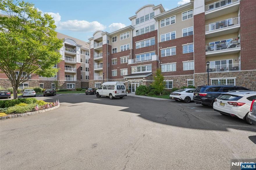 Welcome to this beautiful Colfax END-UNIT condo in the highly desirable Wanaque Reserve, an active adult 55+ community. Move-in ready and filled with natural light, this 2-bedroom, 2-bath home offers picturesque views of the mountains and pond. The open floor plan features unique polished concrete floors, a spacious den with French doors that open to the dining room, and sliding glass doors that lead to a tiled balcony perfect for relaxing. The primary bedroom suite is a true retreat with a tray ceiling, walk-in closet, additional double closet, dressing area, and a private ensuite bath. A second bedroom, full bath, and in-unit laundry provide comfort and convenience. This home also includes TWO DEEDED UNDERGROUND PARKING SPACES. Wanaque Reserve offers a resort-style lifestyle with a clubhouse that features a cafe , fitness center, theater, sauna, ballroom, and both indoor and outdoor pools. With more than 45 clubs and activities, including travel, tennis, pickleball, golf, canasta, and poker, there is something for everyone. This property combines comfort, style, and community in one of the area's most sought-after locations.