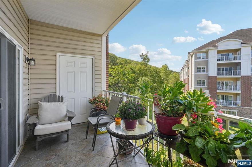 Welcome to this beautiful Colfax END-UNIT condo in one of the newer buildings of Wanaque Reserve, an active adult 55+ community. Move-in ready and filled with natural light, this 2-bedroom, 2-bath home offers picturesque views of the mountains and pond. The open floor plan features unique polished concrete floors, a spacious den with French doors that open to the dining room, and sliding glass doors that lead to a tiled balcony perfect for relaxing. The primary bedroom suite is a true retreat with a tray ceiling, walk-in closet, additional double closet, dressing area, and a private ensuite bath. A second bedroom, full bath, and in-unit laundry provide comfort and convenience. This home also includes TWO DEEDED UNDERGROUND PARKING SPACES. New hot water heater with auto shut off valve. Wanaque Reserve offers a resort-style lifestyle with a clubhouse that features a cafe , fitness center, theater, sauna, ballroom, and both indoor and outdoor pools. With more than 45 clubs and activities, including travel, tennis, pickleball, golf, canasta, and poker, there is something for everyone. This property combines comfort, style, and community in one of the area's most sought-after locations