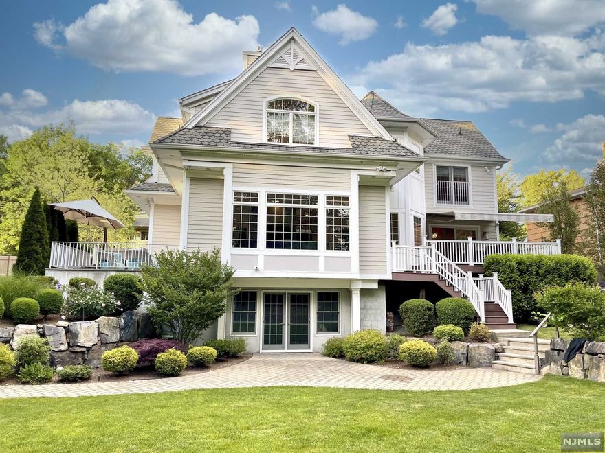 Welcome to this picturesque colonial home in the heart of Alpine. Recently redesigned and renovated with a contemporary design and open layout. New pool just installed. The first floor features a modern eat-in kitchen with an island and breakfast area; a dining room; a family room and two separate outdoor entertaining decks. The second floor features a large master bedroom suite with a walk-in closet, spa-like master bath, and sitting area; two additional ensuite bedrooms; loft office space, and laundry room. The walk-out lower level features an apartment with a separate entrance, kitchen, bedroom, full bath, family room, and laundry room. The backyard is spacious, fully fenced in, and beautifully landscaped. Award-winning schools and minutes to Manhattan. Don't miss this amazing opportunity!