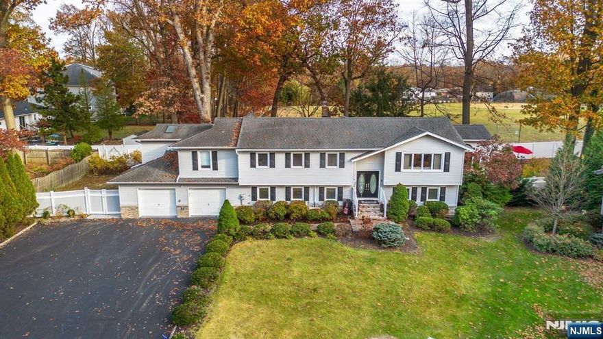 Amazing Packanack Lake custom home. Features include: impressive open floor plan with 5BR, 3BAs, and in-law suite. Main level includes: sun filled living room, an inviting kitchen with granite, center island and separate breakfast room, gorgeous dining room with cathedral ceilings with floor to ceiling windows and tons of natural light. Enjoy the outdoors with charming 3 Season enclosed porch. Live your best life in your fabulous Primary Suite: oversized bedroom with newer bathroom with stylish details and designer dream walk in closet with custom cabinets, skylights and center island. Lower level features: Great Room is perfect for entertaining: fireplace, built in wet bar with beverage refrigerator to enjoy a quite night at home or a fun filled Sunday football day with friends. Brand new in law suite or private office with sitting area, bedroom, kitchen and spa full bathroom. Great options for office or additional bedroom suite.