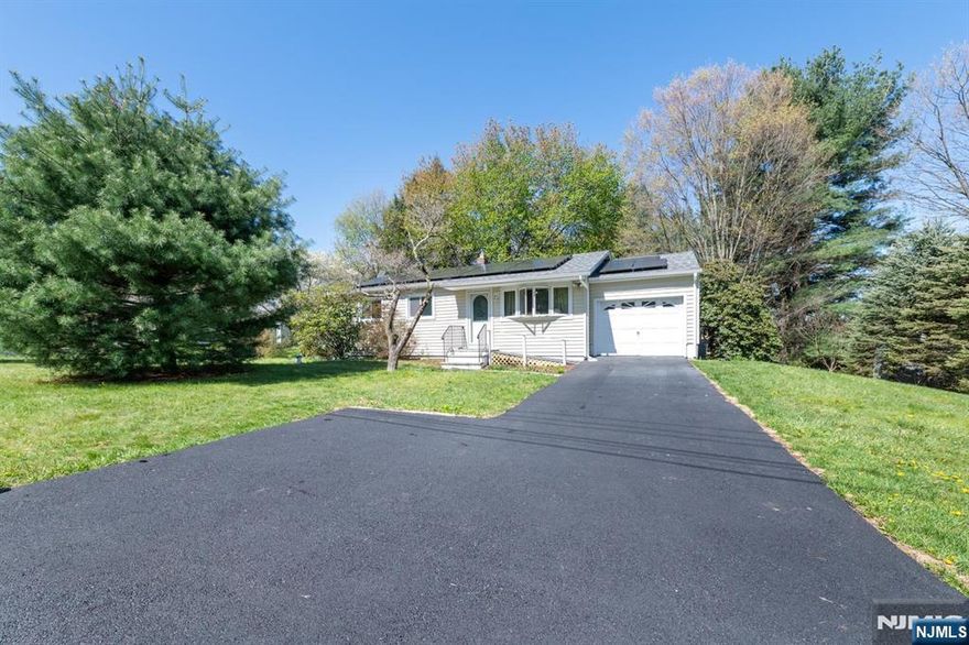 This inviting ranch offers an abundance of storage, with attics above both the living area and the garage, along with convenient shelving above the lighted basement stairs. Legacy hardwood flooring and solid core wood doors create a warm, timeless atmosphere throughout the main level. The custom kitchen cabinetry and a charming bay window overlooking the full width screened patio make the eat in kitchen feel bright, open, and exceptionally spacious. Downstairs, finished bonus rooms provide flexible space for recreation, hobbies, a home office, or whatever suits your lifestyle.
