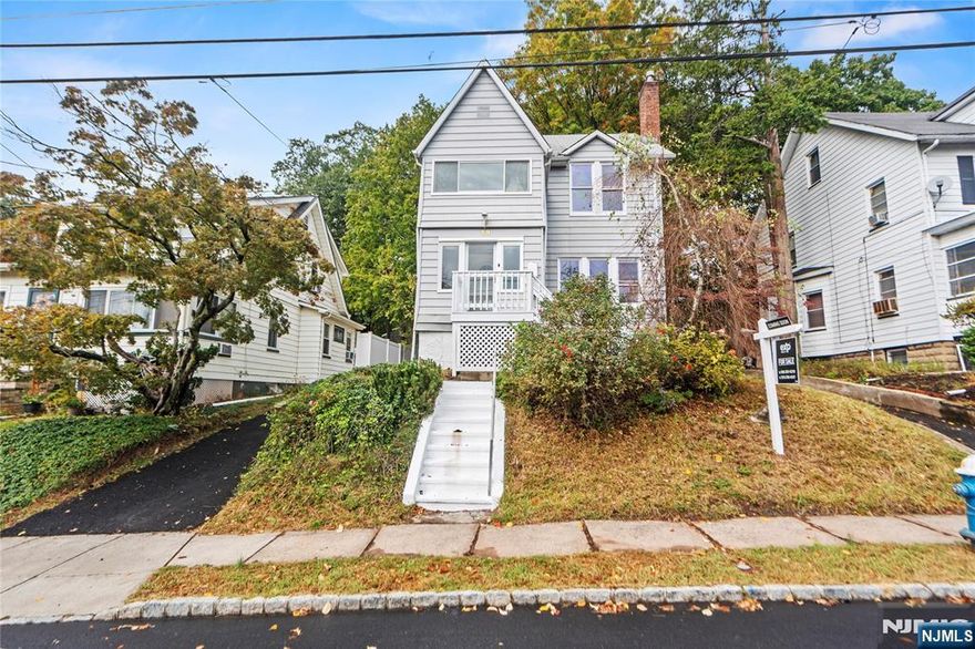 Welcome home to this charming and beautifully updated colonial nestled in the heart of West Orange! Step inside to find a bright and inviting interior featuring a modern kitchen with stainless steel appliances, quartz countertops, and eye-catching patterned tile backsplash. The light-filled living room features large windows, rich hardwood floors, and a cozy brick fireplace framed by custom built-ins. The formal dining room offers elegant millwork and a warm, inviting flowâ€”perfect for entertaining or everyday living. Upstairs, youâ€™ll find three well-proportioned bedrooms and a full bath, plus a versatile bonus space perfect for a reading nook or home office. Enjoy morning coffee or evening sunsets from the enclosed front porch or unwind on the freshly painted back deck overlooking the spacious yard. The newly paved driveway leads to a detached garage, offering plenty of parking and storage. Conveniently located near parks, shopping, restaurants, and NYC transportation, this move-in ready home combines style, comfort, and convenience.
