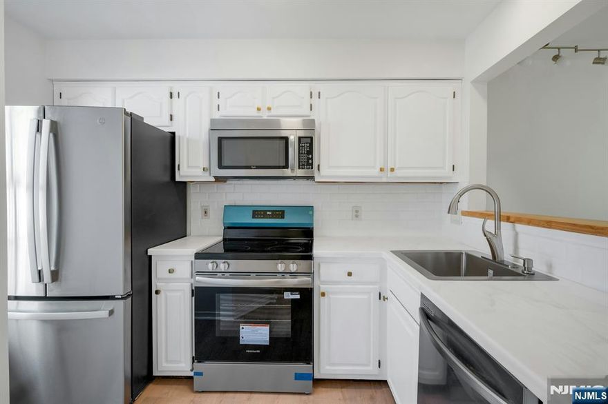 Fantastic, newly renovated one bedroom, one and a half bath townhome with a one car garage in the desirable Panther Valley community! Step into a bright, inviting first floor featuring an updated kitchen with brand-new refrigerator, range/oven, dishwasher, countertops, sink, and backsplash and a fully updated powder room. The living room showcases a cozy wood-burning fireplace and the new sliding glass doors in the dining area open to a serene patio perfect for enjoying your morning coffee or relaxing outdoors. Upstairs, the primary suite offers a walk-in closet and a beautifully updated full bath. The entire interior has been freshly painted and enhanced with new lighting and stunning new flooring throughout, creating a clean, modern feel. Panther Valley is a gated community with exceptional amenities, including three pools, playgrounds, and volleyball, pickleball, tennis, and basketball courts. Conveniently located near schools, parks, shopping, and Route 80, with easy access to New York City, approximately about an hour away. NYC bus service available minutes away, near the entrance to the community. Warm, welcoming, and truly move-in ready - this is one you won't want to miss!