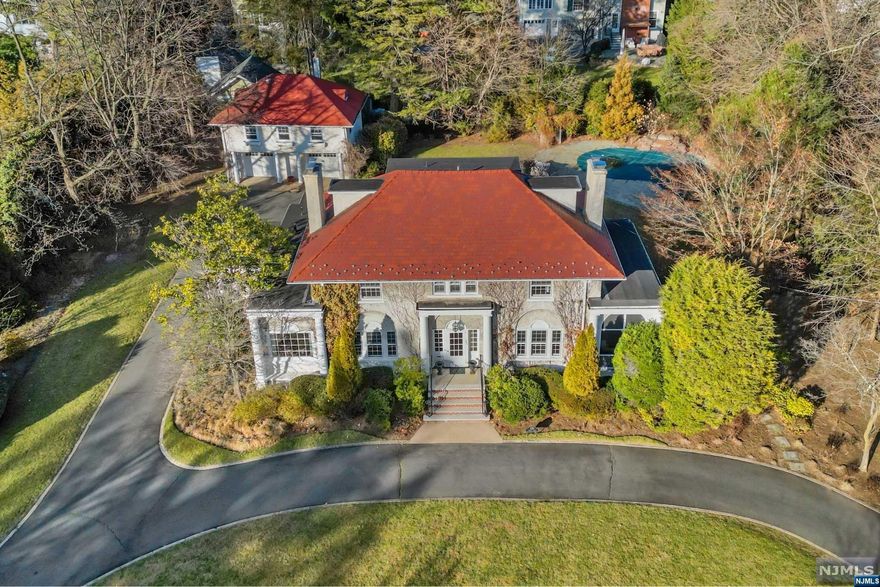 Prepare to be captivated by this one-of-a-kind Willard gem set on one of the most beautiful streets in town! Stately Phelps Road masterpiece set back on 0.8 acres with a backyard oasis that features a freeform gunite pool, waterfall, blue-stone patios, fire pit, and lush landscaping. Six bedrooms total, including two in the carriage house with a full bath and kitchen. Expanded (2007) and thoughtfully renovated with a modern flair while preserving the original character and style. Gourmet eat-in kitchen with a vaulted ceiling, breakfast nook, large center island, and wall of windows at the heart of the home open to mudroom with laundry and flow to the dining room via the wet bar/butler pantry. Freshly painted rooms, a designated office, 3 fireplaces, a large finished basement, a primary suite with a spa-like full bath, a 2-car garage, and a carriage house make this the perfect home for comfortable living and grand-scale entertainment. A spectacular property in a prime location!