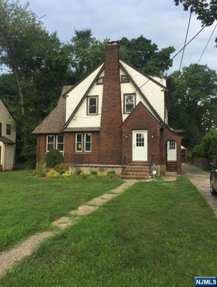 This beautifully renovated Tudor style home is ready to move in. The stove, microwave and dishwasher are brand new. New flooring in the kitchen, bathrooms and basement. The hardwood floors throughout were freshly refinished. A classic fireplace in the living room adds warmth and character. The sun room adjacent to the dining room is bright and internet ready. There are 3 bedrooms and a full bathroom on the second floor, 2 extra rooms upstairs with more closets. Large basement with 1/2 bath with washer and dryer. Detached two car garage with new garage doors. Situated close to Benjamin Franklin Middle school and Travell Elementary school. Close proximity to Ridgewood's vibrant downtown, parks, and NYC transportation. This property offers the ideal balance of suburban tranquility and accessibility. **Proof of income, application and Credit Check Required.**