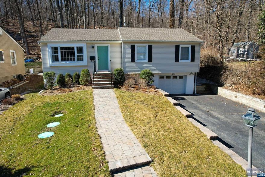 Welcome home! Charming Raised Ranch with 1.5 acres of land. Modern living room and dining room with hardwood floors and French doors that lead to the amazing Great Room. Relax in the sun filled Great Room with vaulted ceiling, skylights, an electric fireplace and sliders to the deck. Enjoy the tranquility of the large private backyard. Master bedroom with walk in closet and a half bath. Stainless steel appliances in the updated eat in kitchen with granite countertop. Hardwood floors throughout. 2 zone heat and 1 zone central air. Oversized one car garage with access to the basement. Plenty of space in the basement for a home office, rec room, den or extra storage. New roof and siding in 2017 and new septic in 2018. Great schools and community.