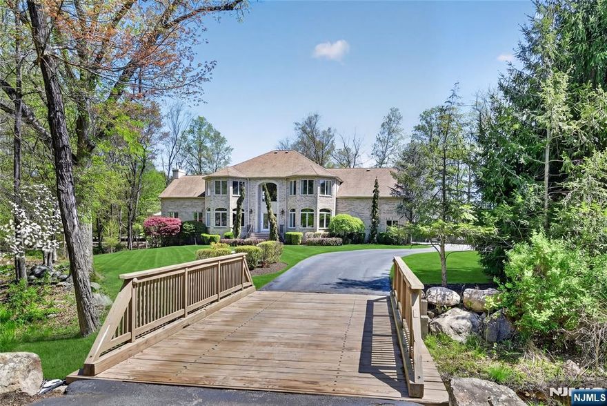 Set within Rio Vistaâ€”arguably Mahwahâ€™s most coveted neighborhoodâ€”this distinguished residence is privately positioned at the end of a cul-de-sac on 3.62 acres. A long approach reveals a stately brick-and-stucco faÃ§ade framed by mature landscaping, elegant up-lighting, and a gentle brook enhancing the serene setting. Inside, a grand two-story foyer with sweeping staircase introduces a thoughtfully designed layout. The main level offers seamless flow for everyday living and entertaining, featuring a sunlit dining room, oversized living room with panoramic views, and a front-to-back great room with tray ceilings, hardwood floors, custom inlays, and a gas fireplace with marble surround. The kitchen is well-appointed with a 36" Viking range, center island, and maple cabinetry, opening to an expansive composite deck with modern cable railing, built-in gas fire table, and gas line for grilling. A first-floor bedroom with ensuite bath, plus laundry, powder room, and pantry, add flexibility. Upstairs, four bedrooms each offer ensuite baths; the primary suite includes tray ceiling, sitting area, dual walk-in closets, office/meditation room, and a spacious bath with soaking tub and walk-in shower. A full unfinished basement (~2,200 SF) with egress windows and two staircases offers endless potential. 3 Car Garage, four-zone HVAC system, 300-amp electrical service, most-of-house generator with automatic transfer switch, advanced water filtration systems and a view from every room!