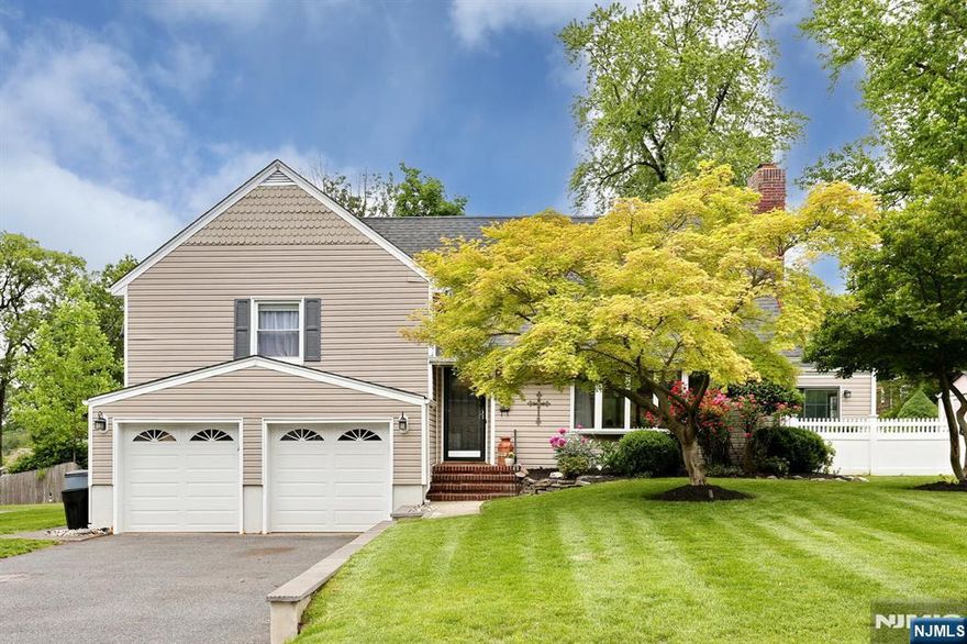 Welcome home to this spectacular split level on a tree lined street. Boasting hardwood flooring and plenty of natural light, you will love the open concept space. The updated kitchen features beautiful quartz countertops, farmhouse sink and Viking Range accented with glass backsplash. The family room focal point is the woodburning stone fire place perfect for gatherings. Beyond the dining room is the sun room accessible through a split farmhouse door. Fall in love with this perfect space to unwind with soaring cathedral ceiling and sliding glass doors all around. The second level features two well appointed bedrooms with an updated full bath. The primary suite is spacious with hardwood floors, walk in closet and updated full bath. The lower level is a convenient office space that connects the large two car garage, rear backyard access and updated full bathroom. The basement is fully finished with ceramic tile, wet bar with granite countertop, laundry area, storage and utility closet. The backyard is the ultimate fun space. Enjoy the season in the large in-ground pool. The fenced in level yard with underground irrigation system is great for parties, bbq's and leisure. The wood patio and shed complete this entertaining space. Close to parks, major highways and schools, you don't want to miss this one!