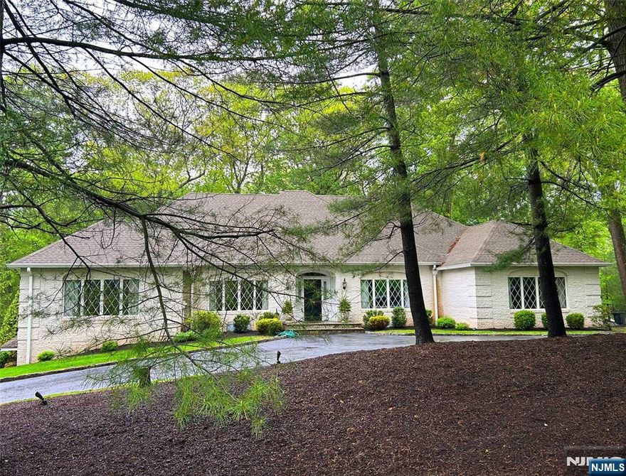 This sprawling brick ranch on a dead end street in sought after Franklin Lakes awaits your finer touches. Positioned on .89 acre, this beautiful home offers formal living room, and formal dining rm. The massive eat kitchen boasts tons of cabinets & counter space, ideal for that chef in you! The great room has inlaid wood flring & stone fireplace. Off the kitchen is large eating area w/SGD to deck & separate den with tile flr and large windows (could easilly be converted to 4th br). The primary bedroom has double walk in closets & primary bath with tub and shower stall. 2 additional spacious bedrooms with full main bath, powder room and laundry room finish the main level. Basement has newer full bathroom and potential for large recreation rm. There is a 3 car garage with access into the cavenous lower level, perfect for car collectors! Separate office area w/exterior access & access to garages is calling out for someone who needs to work from home. Home has a 30 ft drainage easement on right side. See town tax maps. The potential is endless! A must see!