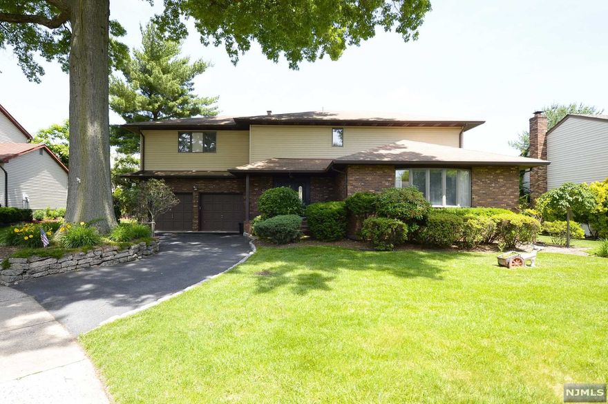 Welcome to this beautiful four bedroom two and half bath Colonial home nestled on a quiet cul de sac in desirable Fair Lawn. Pull right into your double driveway or walk right into your spacious entryway with vaulted ceilings that welcomes you home everyday! The first floor features a kitchen with breakfast nook, living room, formal dining room, a half bath, and a family room with a wood burning fireplace! Walk up stairs and be wowed with this home's large primary bedroom suite complete with hardwood flooring, large walk-in closet and primary spa like bathroom, three additional bedrooms and another full bath complete this level! Finally this home features a full sized basement with tons of storage and lots of potential! Enjoy this summer with your private backyard perfect for winding down or entertaining guests! Close to Nyc transportation, shopping, & schools.