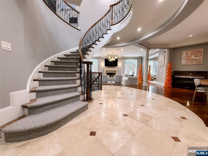 Exceptional 4BR, 4 full & 2 half bath townhome in the sought-after Bellaire Townhomes community overlooking Alpine Country Club. Enter through a dramatic 2-story foyer into an open-concept main level featuring a custom gas fireplace and access to a private patio with golf course views. The eat-in kitchen offers stainless steel appliances, center island, and separate dining area. French doors lead to a custom office. Elevator access to all floors. The primary suite includes a gas fireplace, spa-like bath with soaking tub, large shower, double vanity, and expansive closet. Two additional en-suite bedrooms plus a fourth bedroom complete the second level. Finished lower level with rec area, theater, full bath, and private room with adjacent full bath ideal for guests or flex space. Includes an attached two-car garage with interior access.