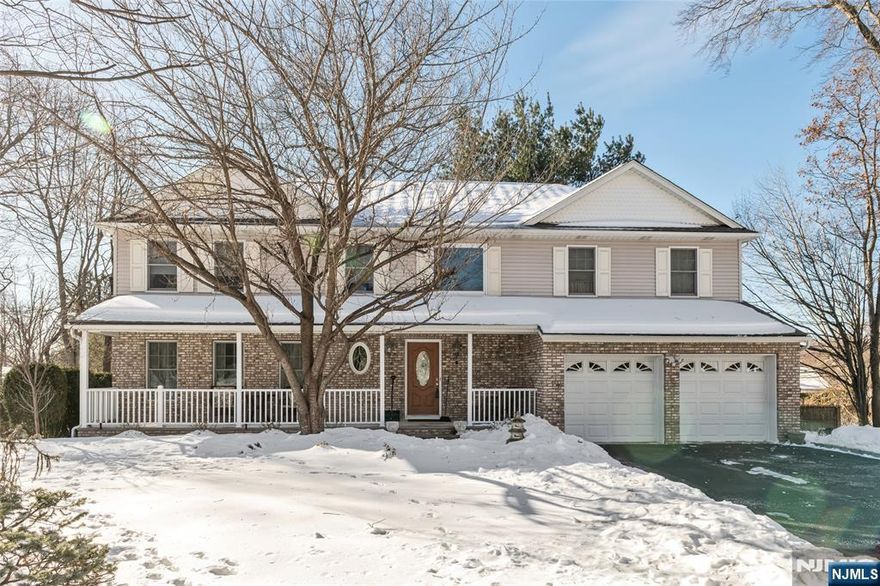 Nestled on a quiet cul-de-sac in desirable Park Ridge, NJ, this 4-bedroom, 2.5-bath side hall Colonial offers comfort, space, and abundant natural light throughout. A charming covered front porch welcomes you homeâ€”perfect for enjoying your morning coffee. Beautiful wood floors flow seamlessly across the inviting layout. The first floor features a welcoming living room, formal dining room, powder room, and a spacious kitchen designed for gathering, complete with a center island, abundant cabinetry, granite countertops, and stainless steel appliances. A bright breakfast area with sliding doors opens to a deck with a gas line for your BBQâ€”ideal for effortless outdoor entertaining. The peaceful backyard provides a serene setting for relaxation. Just off the kitchen, the great room with fireplace creates a warm and inviting space, and convenient garage entry completes the main level. Upstairs, the primary suite offers a large walk-in closet and a spa-like bath with double vanity, jacuzzi tub, separate shower stall, and private toilet area. Three generously sized bedrooms, a full hallway bath, and second-floor laundry add everyday convenience. A full unfinished basement offers endless possibilities for additional living space, a home gym, or recreation area.
