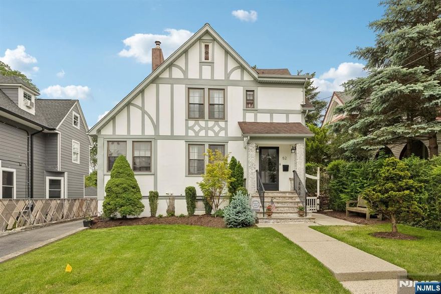 Welcome to Little Falls! This charming Tudor-style home offers 3 bedrooms, 2.1 baths, and a spacious, well-maintained park-like property. The1st floor features a wood-burning fireplace, formal dining, 1/2 bath, and a bright den ideal for a home office or cozy sun room. Enjoy a unique leisure area with built-in bench seating & hidden storage. Step down to a large eat-in kitchen, with double doors leading to a breathtaking outdoor space; great for entertaining.The yard features a paver patio outlined with a wooden pergola & two ceiling fans for cooling off on hot days, lush landscape & a custom stone pizza oven. An outbuilding with electric, wood floors, and a wood burning stove offers additional flex space perfect for a studio. The partially finished basement includes two rooms currently used as a rec room and den with a heated floor, plus a laundry room. Recent updates include a tankless hot water heater & central air/heat.Upstairs, find a vaulted-ceiling bedroom with a surprise loft area used as a dressing room, a 2nd bedroom, and a full bathroom. The primary bedroom has vaulted ceilings and plenty of windows, an oversized closet, a walk in closet, & an updated private bath. Located in a community-focused neighborhood with convenient access to shopping, dining, transit, places of worship, & parks - this is a must-see! This quaint town is 20 minutes outside of NYC with the train station a few blocks away. You're going to love all that this home and township has to offer!