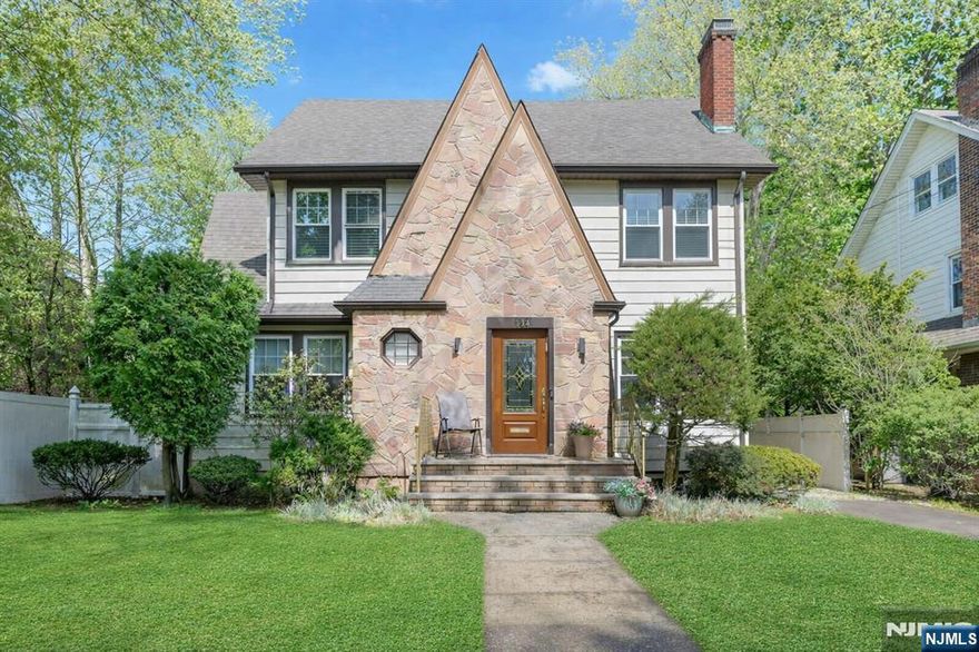 Lovely Tudor Colonial on prestigious West Englewood Teaneck Street. Spacious first floor has a formal living room with wood burning fireplace, formal dining room, study/office. two powder rooms, a large family room adjacent to the updated double appliance kitchen with granite countertops, a large island, tremendous cabinet space and an eating area with glass doors to the gorgeous professionally landcaped backyard with a heated inground pool. Second floor has huge primary bedroom with cathedral ceiling and full bath plus three additional bedrooms and full bath. There is a walk up attic for storage. Finished basement has full bath. The detached garage was converted to a home office. Two Zone central air, 5 zone heat, ug sprinklers, mostly hardwood floors, loads of closet and storage space. Close to houses of worship, transportation, parks, schools, and shopping.