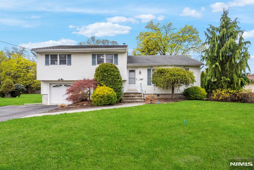 Welcome to this wonderful 3 bedroom, 2.5 bath split level home located in a beautiful, walkable neighborhood lined with trees and close to shops and restaurants. Excellent curb appeal! This home has been professionally cleaned and is ready for new owners to make it their own. Inside, you'll find hardwood floors, a functional layout, and generous storage throughout. The main floor features an eat-in kitchen, a spacious living room, and a formal dining room filled with natural light. Sliders off the dining room open to a deck overlooking a level, sprawling yard perfect for relaxing, playing, or entertaining. All three bedrooms have hardwood floors and good closet space. The ground level includes an inviting family room with easy access to the rear patio and yard, creating a great indoor-outdoor flow. An unfinished basement and bonus area offer even more storage or future potential. One car garage and ground level laundry room complete the space. A brand new septic system will be installed before closing. Home is being sold as is, part of an estate.