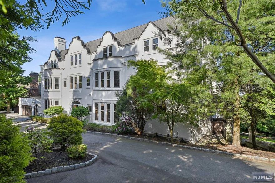 Elegant and beautifully built in 1912 this perfectly updated manor house overlooks the NYC skyline. Incredibly spacious with gorgeous architectural details, 9 fireplaces, and leaded glass windows throughout. Terrific renovated eat-in-kitchen with pantry is just off a family room and lavish formal dining room. Lofty ceilings throughout. Dramatic living room plus library/office on the first floor. Nine sunny bedrooms with eight baths on the top two floors. Finished lower level with bedroom suite, playroom, media room, and storage. Situated on over an acre of lovely landscaped, tiered very private property with an expansive terrace. Set on a charming cobblestone street in one of Montclair's premier locations, this is a uniquely special home for the ages!