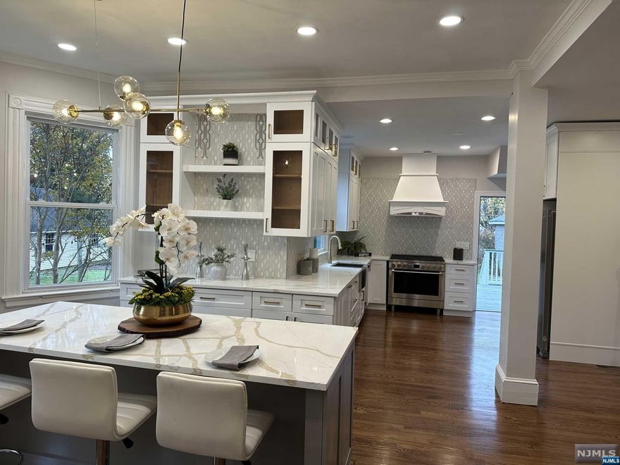 Beautifully maintained & updated turn of the century Victorian in the heart of Ridgewood on almost half an acre lot. Enjoy the wrap around porch that welcomes you into the character-filled entry foyer with fire place and admire the high ceilings, gleaming hard wood floors and detailed woodwork. Main floor features Living Room, Family Room with its own fireplace and Dining Room, and wonderful natural light throughout. An oversized deck off the kitchen overlooking the beautiful secluded garden filled w/ mature plantings. Second floor has 4 Bedrooms, 2 Baths including Primary Bed/Bath and ample closet space. Third floor has Rec Room with additional 2 Bedrooms. Some of the updates include new siding, new gutter, new kitchen with island, new baths, New HVAC system and... This home is located in the Graydon area, central to everything - school, library, downtown shops restaurant, NYC bus and trains. Don't miss this opportunity to make it yours!