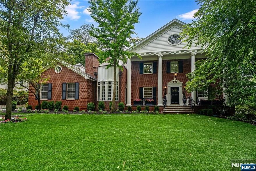 Welcome to " TARA ON THE EAST HILL", a stately all-brick Georgian Colonial is a rare gem. Set on a manicured nearly half-acre lot, it offers 6,200+ sq ft of exquisitely renovated living space across four finished levels. A sweeping staircase greets you in the grand entry, leading to elegant, light-filled rooms with custom millwork, barrel, tray, and vaulted ceilings. French doors from the Great Room and den invite seamless indoor-outdoor living. No expense spared! The chefâ€™s kitchen is the heart of the homeâ€”complete with two oversized islands, a butlerâ€™s pantry, 2 sinks, 3 dishwashers, & top-tier appliancesâ€”designed for entertaining & everyday ease. Formal & informal spaces include a wood-burning LR fireplace, richly paneled library with private entrance, and expansive dining room. Retreat upstairs to a luxurious primary suite with spa-like his & hers baths, walk-in closets, and private terrace. A second suite, Jack-and-Jill bedrooms, and third-floor bedrooms offer flexible living. The finished lower level includes large rec rooms, full bathroom, storage, home office with yard access, and laundry. 2nd staircase. Dual heating systems throughout the home (Radiant heat, steam radiators, and zoned HVAC) ensure year-round comfort. Just 10 miles from Manhattan, near top schools, worship, and downtown Englewood. Walk to worship, shopping, parks& transportation. A home of craftsmanship, character, and modern luxuryâ€”this one must be seen.