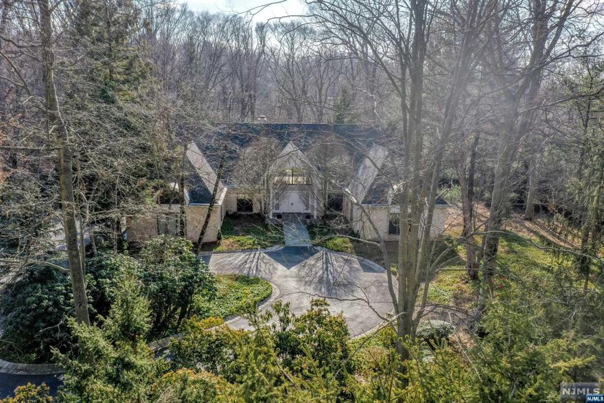 Custom built by the original owners, this gracious expanded ranch is located in the beautiful Chestnut Ridge area of Saddle River. Private setting. Perfect house for entertaining inside and out. Entering the large formal foyer, there is a spectacular great room with fireplace overlooking patio & private rear property. Sun filled primary suite on the 1st floor with many custom built-in closets, separate water closet, and large bath with whirlpool. Also included is a large 2nd en-suite bedroom, a beautiful family room w/fpl and built-ins, a lovely formal dining room with custom built-in closets for Crystal & China, and additional sitting rm is located off the main foyer which could be used for an office or library, playroom/computer rm w/bath. Laundry rm, powder rm, and 3 car garage complete the 1st floor. The second floor features 2 private and spacious bedrooms en-suite. The basement is currently unfinished. Circular drive, security system complete this beautiful home.
