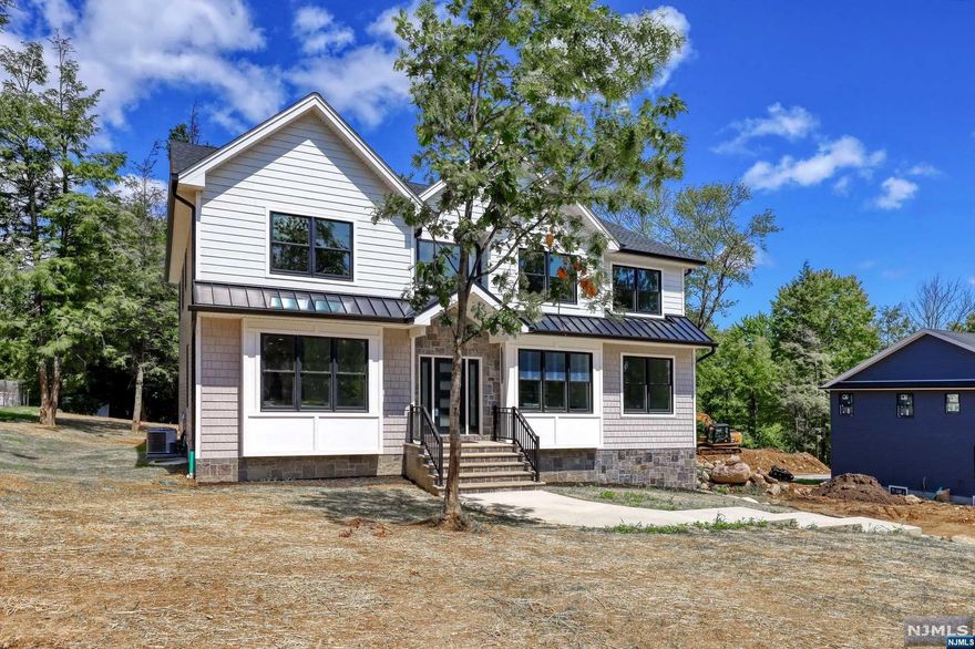 Spectacular NEW CONSTRUCTION w/top amenities completed. Builder is offering quality craftsmanship! A wonderful opportunity to own your dream home in Passaic County. Boasting 6BDR, 4BTH, 3-car garage & offering all the bells & whistles. This home is destined to impress. Featuring exquisite hardwood floors, ultra-high ceilings, tray ceilings, grand entry foyer w/stunning living room, dining room, family room w/open concept feel plus fire place, & kitchen built for a chef, top-tier appliances leading to the patio. Convenient 1st floor bedroom/guest room office and full bath. 2nd floor offers master suite which also includes WIC four more bedrooms, laundry room and 3 baths, finished basement and 3 car garage.