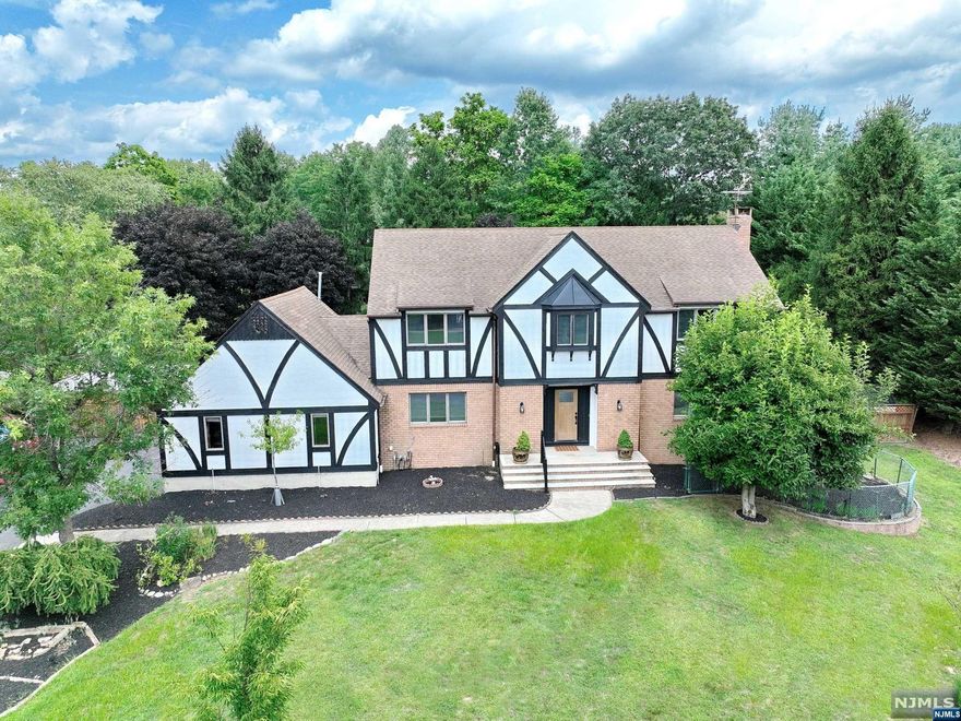 Stately Tudor at the end of a beautiful cul-de-sac, nice lot size with fenced in backyard. Brand new front door welcomes you into this updated home, freshly painted and new flooring throughout with 2-story sunlit foyer, dining room, kitchen with breakfast area, huge living room with fireplace, first floor laundry, storage room, and full bathroom complete this first level. 3 spacious bedrooms, main bathroom and primary ensuite bedroom with 2 walk-in closets on the second level. Full finished basement with a second fireplace and full bathroom, a covered walkout stairway also serves as greenhouse with strawberry and herb isle leads to the backyard. Staycation starts right here - inground pool, gazebo, pergola and an oversized deck to host any parties, mature fruit trees and grape vine arbor plus 2 sheds and plenty of space to add an outdoor kitchen! Don't miss this opportunity, motivated seller priced to sell!