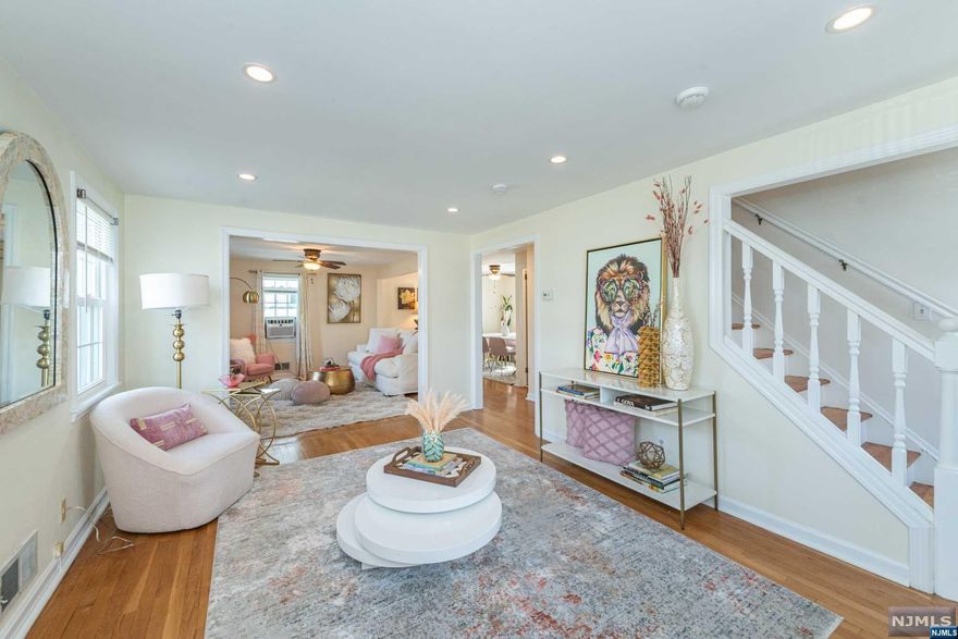 Sun-drenched & spacious rooms are the hallmark of this adorable custom colonial/cape cod, boasting a bright living room adjacent to large sitting room w/ open plan to the dining room, Plus lovely renovated full bath on 1st floor. Ample kitchen features solid wood cabinetry, stainless steel appliances, tile backsplash & granite counters, perfect for the avid home chef! Upstairs highlights 3 restful bedrooms: a generous primary w/ beautifully appointed full bath & double closets. Potential in the freshly painted full height basement w/ utility, laundry & plenty of room for rec room of your dreams! Step out to the lush, green yard & be greeted by a pretty paver patio, privacy landscaping all around, as well as a 1-car detached garage for parking & extra storage. W/ gleaming hardwood floors, recessed lighting throughout & newer windows, this modern sweetheart of a home is conveniently near NYC transportation/shops/restaurants/schools /parks. Perfect for commuters & entertainers alike!