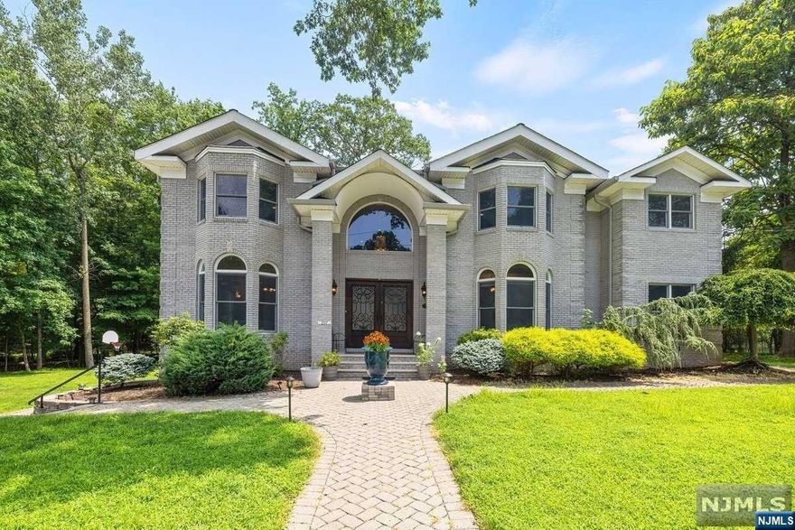 The stunning all brick center hall colonial, situated on a DEAD END St in a town known as one of the best places to live in NJ. This meticulously cared 5 Brs and 4.5 Bths home featuring double iron doors open up to grand entrance with beautiful chandelier welcoming you to the main level offering a powder rm, 3 entertain rms with a wet bar, great living rm with fire place, a br and gourmet eat-in-kitchen, center island leads to covered outdoor patio. A grand staircase leads to the 2nd level offering Primary suite with Juliet balcony, 3 brs and 2 fbths. The finished walk out lower level offers an office, recreation rm, wet bar, full bath, laundry rm, utility rm and 2 Car Oversized Garage. This Luxury Estate is an entertainer's delight boasting spectacular rooms with beautiful custom moldings, architectural details, high end quality and craftsmanship throughout. Golf and country club is less than a half mile away and in close proximity to NYC transportation and award winning schools.