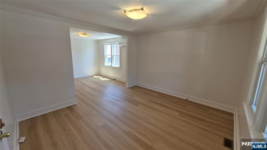 Bright and recently renovated 2-bedroom, 1-bath rental featuring a charming front porch and abundant natural light throughout. This well-maintained home offers a spacious formal living room, dining room, and a full kitchen, providing a comfortable and functional layout. Enjoy generous storage, including large walk-in closets, and a freshly painted interior for a clean, modern feel. Tenants have exclusive access to a basement laundry area for added convenience. Equipped with central air and heat for year-round comfort. Ideally located within walking distance to parks, shopping, and NYC transportation. Street parking available. One pet permitted (maximum 40 lbs).